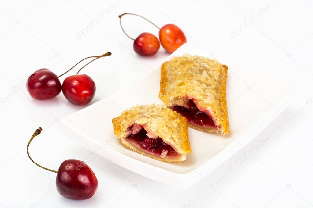 Puff pastry with fresh cherries on a white