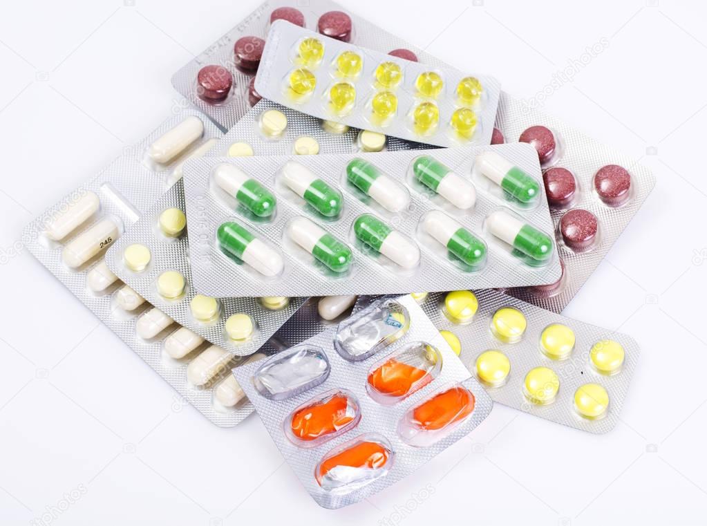 Medical bottles and foil blisters with the capsules and tablets