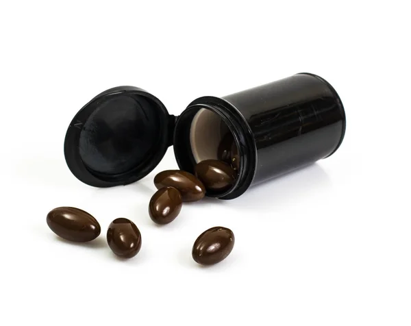 Traditional medicine: brown herbal capsules — Stock Photo, Image