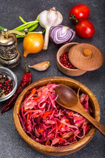 Salad of cabbage, carrots, beets and butter in a wooden bowl, re — Stock Photo, Image