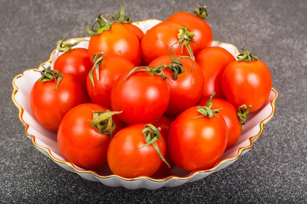 Fresh small tomatoes in white salad bowl — Stock Photo, Image
