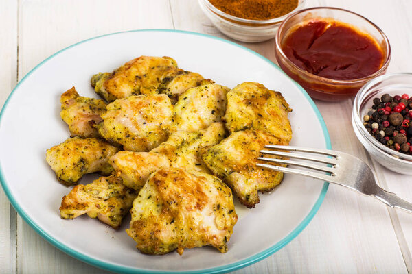Pieces of fried chicken in breadcrumbs on plate