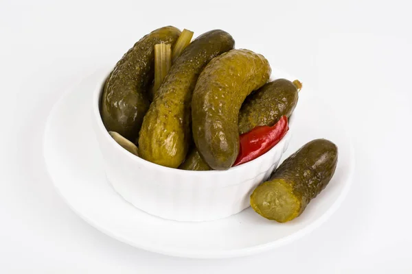 Marinated cornichons in white bowl — Stock Photo, Image