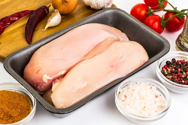 Chicken breast fillets raw in food packaging tray