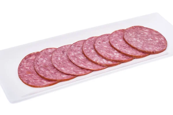 Rebanadas de salami en plato blanco — Foto de Stock