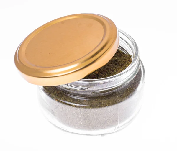 Ground dried herb spices and spices in glass jar — Stock Photo, Image