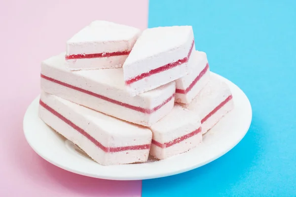 Vit marshmallow med tranbär lager på pastell bakgrund. — Stockfoto