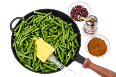 Beyaz zemin üzerine yeşil fasulye tavada parçaları kesilmiş