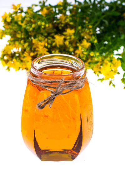 St. Johns wort in glass jar on white background. — Stock Photo, Image