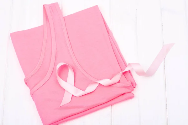 Healthcare and medicine  symbol - pink breast cancer awareness ribbon on female shirt
