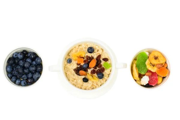 Health and Fitness food. Oatmeal porridge with berries and dried fruits — Stock Photo, Image