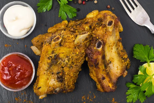 Pork ribs grilled with herbs on black background — Stock Photo, Image