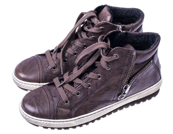 Brown womens boots with laces on white soles — Stock Photo, Image