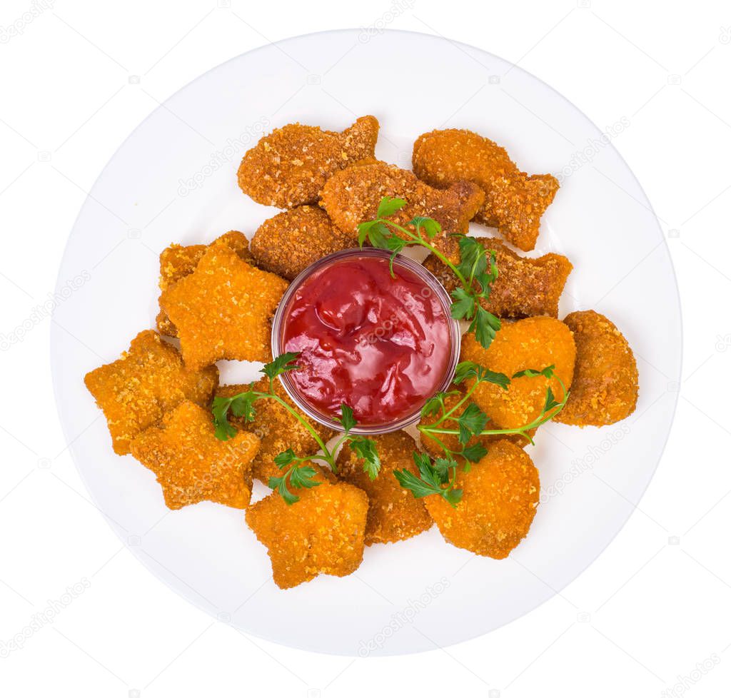 Nuggets of different shapes with ketchup on white background