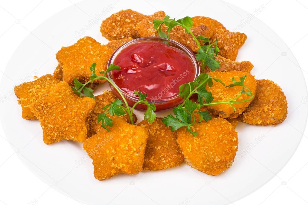 Nuggets of different shapes with ketchup on white background