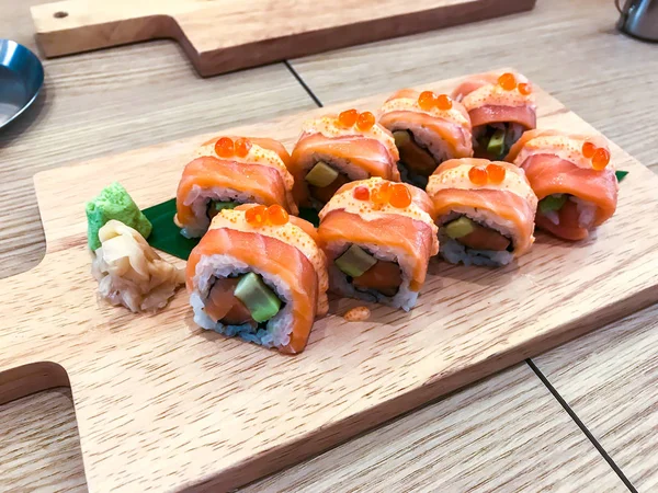 Set of different sushi and rolls on wooden board — Stock Photo, Image