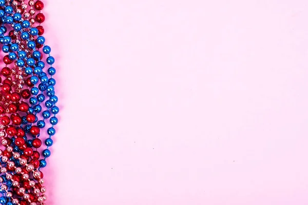 Multi color Mardi Gras beads on bright background — Stock Photo, Image