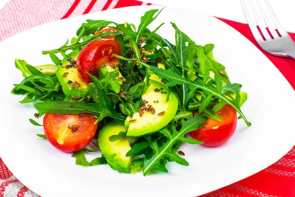 Salade diététique légère à base de roquette, avocat, tomates et graines de lin — Photo