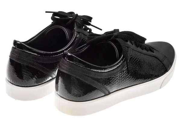 Μαύρη γυναικεία παπούτσια με κορδόνια στα λευκά πέλματα — Φωτογραφία Αρχείου