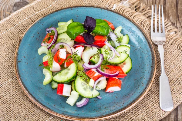 Spicy surimi salad on blue plate — Stock Photo, Image