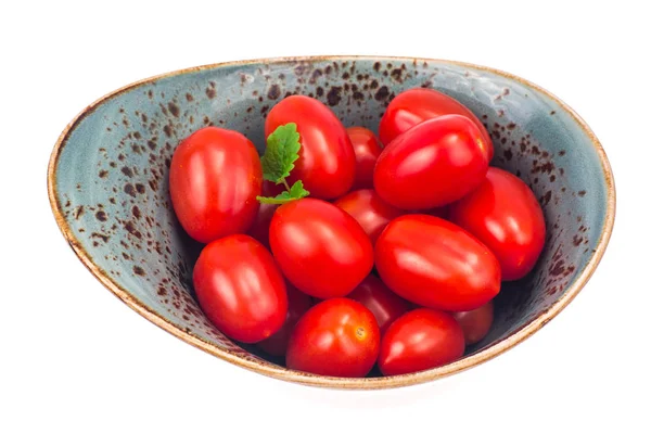 Petites tomates rouges de forme ovale en assiette bleue — Photo