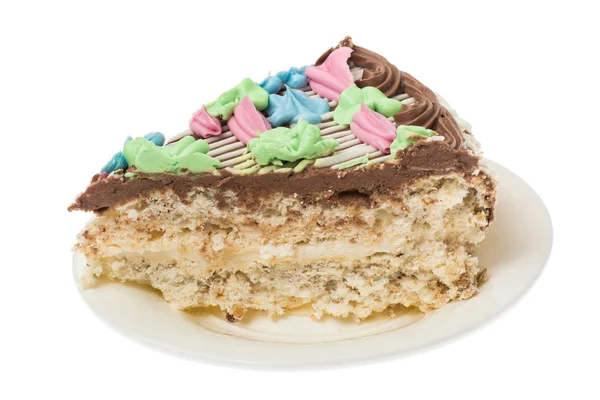Meringue торт с орехами, украшенный цветными цветами из сливок — стоковое фото