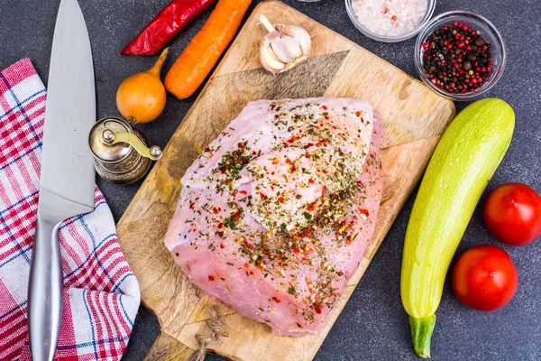 Piece of turkey fillet, marinated in spices, fresh vegetables for cooking