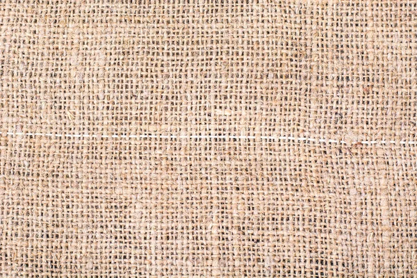 Sackcloth texture on wooden table — Stock Photo, Image