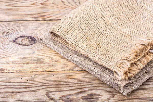 Текстура мешковины на деревянном столе — стоковое фото