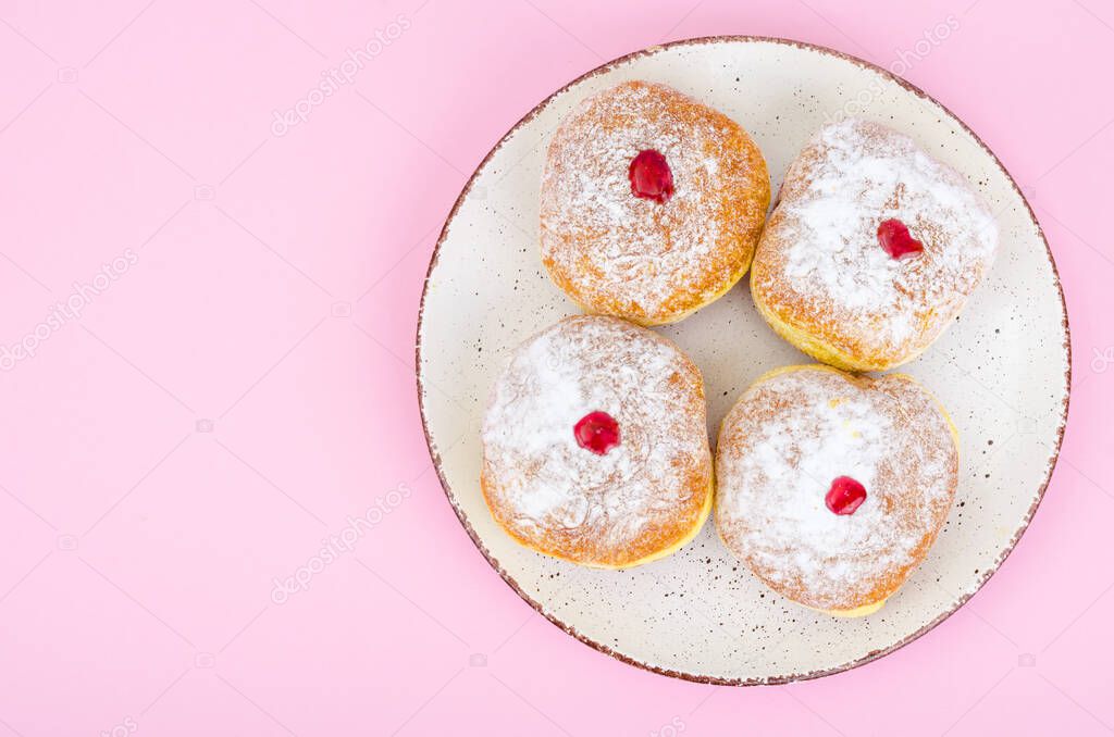 Traditional food doughnuts with icing sugar and jam. Concept and background Jewish holiday Hanukkah. Studio Photo