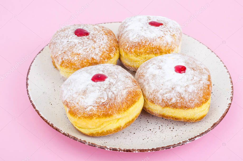 Traditional food doughnuts with icing sugar and jam. Concept and background Jewish holiday Hanukkah. Studio Photo