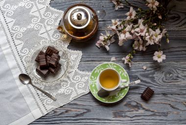 Rustik natürmort. Yararlı, sıcak bitkisel çay, şeker ve badem çiçekli dallar üzerinde ahşap masa yakın çekim