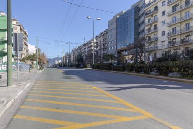 02/29/220. City of Athens, Greece, district Ambelokipi. Modern view of Alexandras Avenue, cars, motorcycles and buildings in downtown morning on a sunny, winter day
