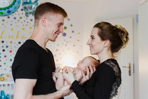 Young Parents Hold Newborn Arms Look Each Other Smile — Stock Photo, Image
