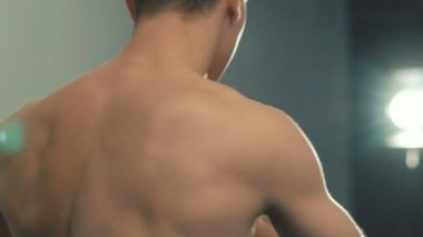 Kapatmak yukarıya-in yakışıklı sporcu spor salonunda vücut kneads. Ağır çekim