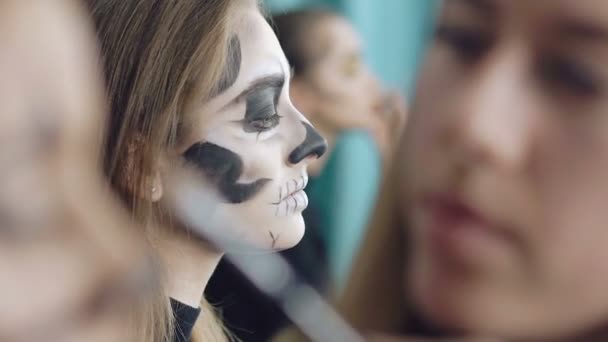 Künstler zeichnet Mädchen Totenkopf-Make-up im Kunstatelier — Stockvideo