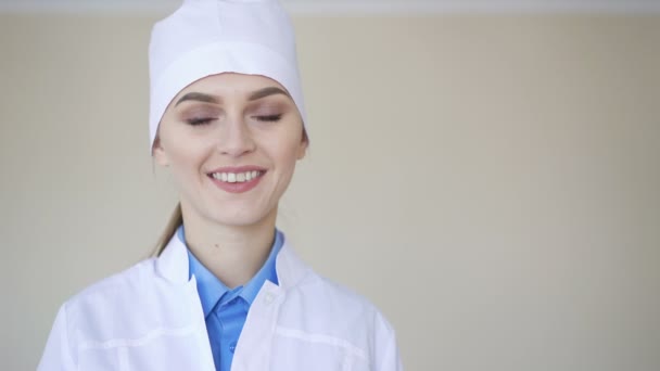 Retrato de una joven doctora adulta, mirando a la cámara y sonriendo — Vídeo de stock
