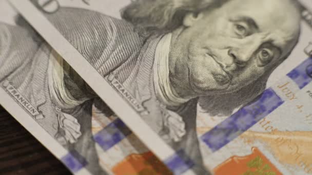 Beaucoup de cent dollars tombant sur la table en 4K 