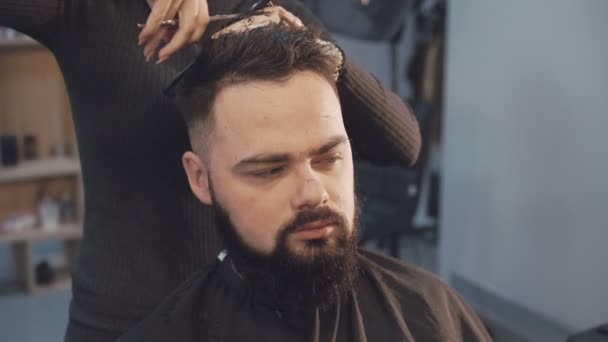 Cortador de cabelo feminino cortando o cabelo masculino na barbearia 4K — Vídeo de Stock