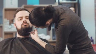 Bayan Kuaför erkek istemcinin sakal saç keser