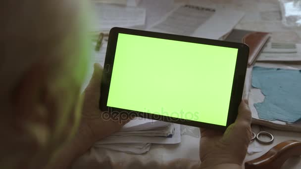 Een lege tablet Pc in de afdrukstand liggend met een groene screenin handen. 4k — Stockvideo