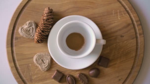 Wooden background of pouring hot coffee, candies and biscuit in 4K — Stock Video