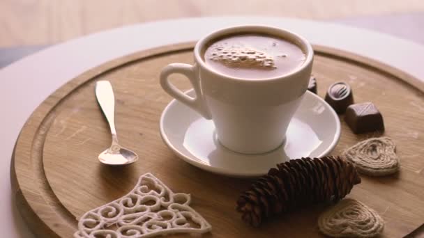 Close up rotating wooden background with coffee, candies and biscuit — Stock Video