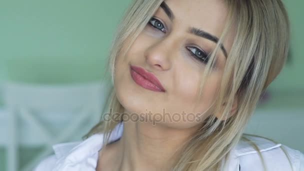Close-up van de mooie blonde glimlachend en poseren voor camera — Stockvideo
