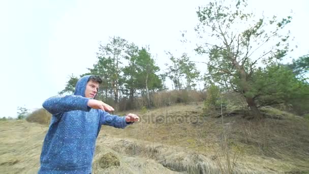 Молодой человек тренируется на природе — стоковое видео