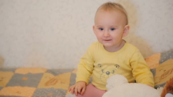 Adorable 1-year baby playing with teddy bear — Stock Video