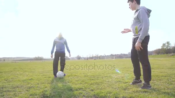 Két boldog fiúk játszani labdát a labdarúgó-stadion, 4 k