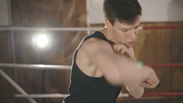 Handsome sportsman training beats on the ring in a gym — Stock Video