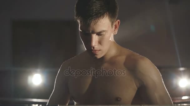 Portrait of boxer stands under water splashing on ring looking at camera. Slowly — Stock Video