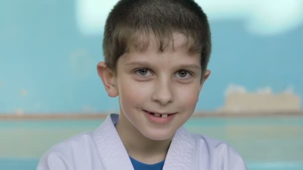 Bonito menino lascado olhando e sinceramente sorrindo para a câmera no ginásio Lentamente — Vídeo de Stock